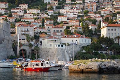 Boats moored at harbor in town