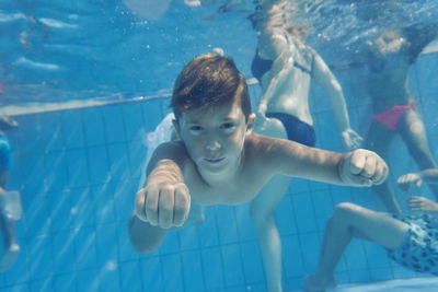 Portrait of boy swimming in pool