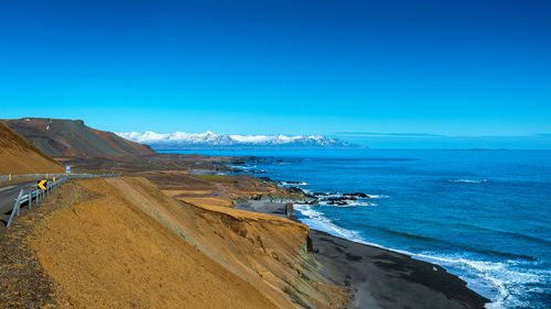 Scenic view of sea against clear blue sky