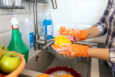 Midsection of man preparing food in kitchen at home