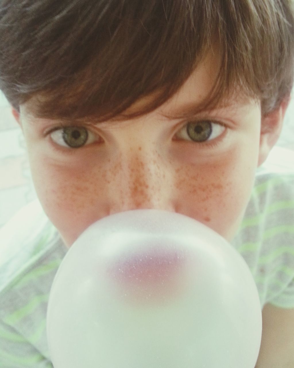 headshot, lifestyles, close-up, person, indoors, looking at camera, portrait, human face, leisure activity, front view, head and shoulders, focus on foreground, childhood, young adult, elementary age, human eye, holding