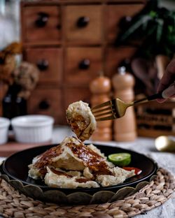 Close-up of hand holding food on table