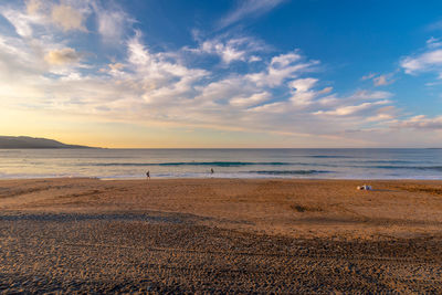 Scenic view of beach against sky during sunset