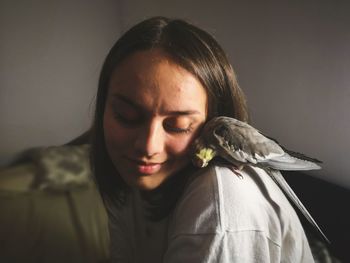 Portrait of woman looking at bird