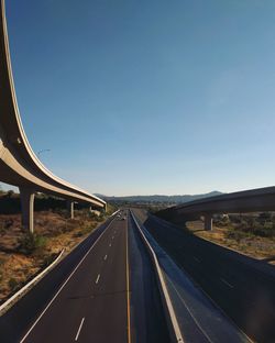 Highway against clear blue sky