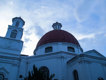 Low angle view of church and building against sky
