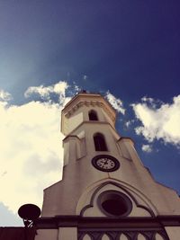 Low angle view of clock tower against sky