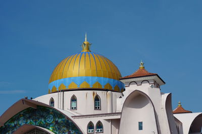 Low angle view of building against clear blue sky