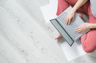 Midsection of woman holding book