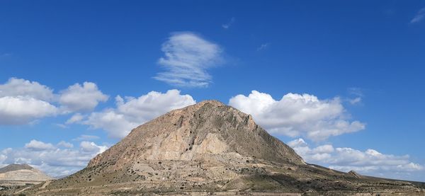 Low angle view of rocky mountain against sky