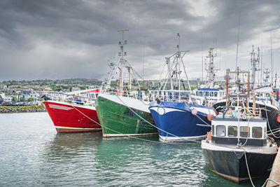 Several colourful fishing boats moored in howth harbour, dublin, ireland