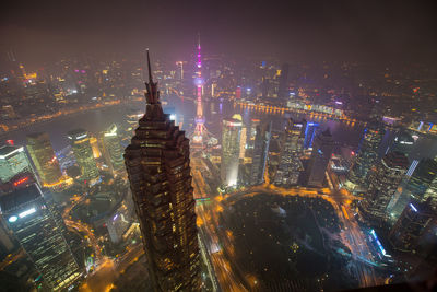 High angle view of city lit up at night