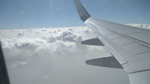 Close-up of airplane wing against sky