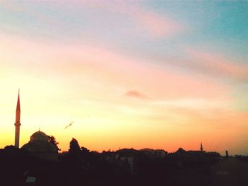 Silhouette of built structure against sky at sunset
