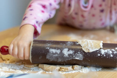 Close-up of woman preparing food on table