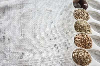 High angle view of spices in spoons on table