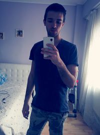 Portrait of young man using mobile phone