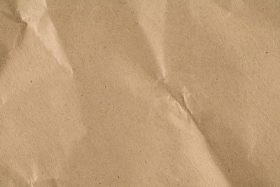 High angle view of paper on sand