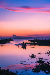 Scenic view of lake against sky during sunset