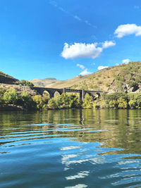 Scenic view of sea against sky with a bridge