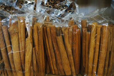 Close-up of cinnamon sticks are in a plastic bag for sale in market
