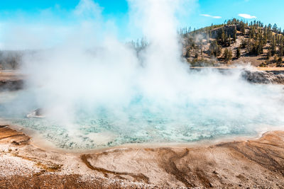 Steam rising from the turquoise pool, yellowstone national park