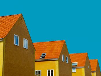 Exterior of houses against clear blue sky