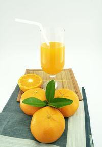 Yellow and orange juice on table