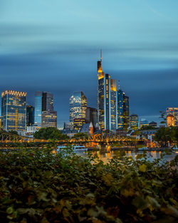 Illuminated buildings in city against sky