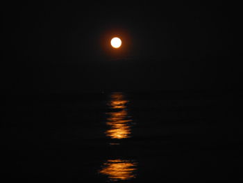 Scenic view of sea against sky at night