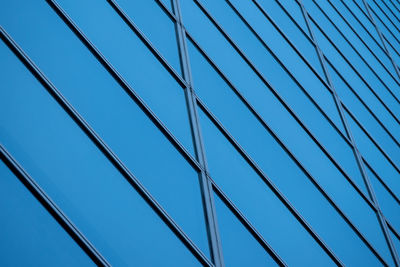 Low angle view of modern building against clear blue sky