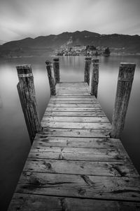 Pier over lake against sky