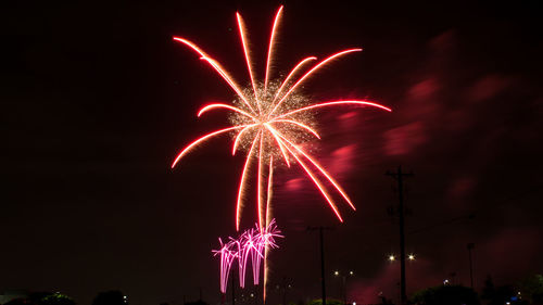 Low angle view of firework display at night