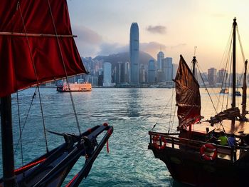 Boats on victoria harbor against two international finance center