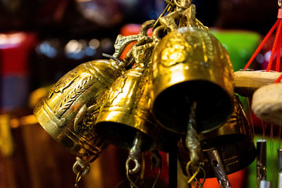 Close-up of bells hanging in store for sale