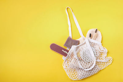 High angle view of hat on table against yellow background