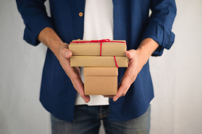 Midsection of man holding paper in box