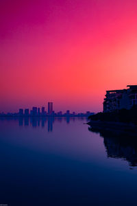 Scenic view of river against romantic sky at sunset