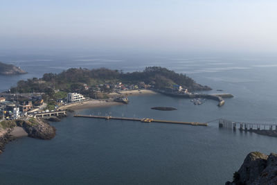 High angle view of sea and city against sky