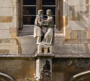 Statue against historic building