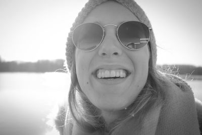 Portrait of a smiling young woman against sky