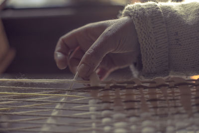 Close-up of hand playing guitar