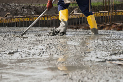 Low section of worker working at construction site