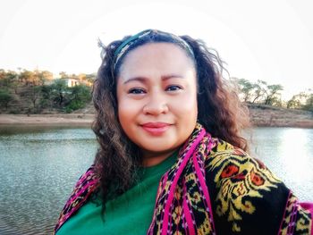 Portrait of smiling young woman in lake