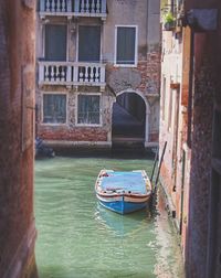 Boats in canal along buildings