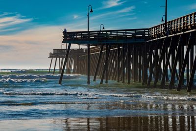 Pier over sea against sky