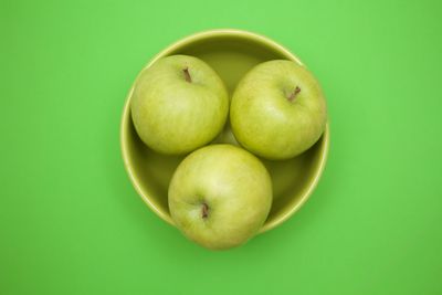 Close-up of apples on green background