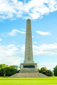 Low angle view of monument against cloudy sky