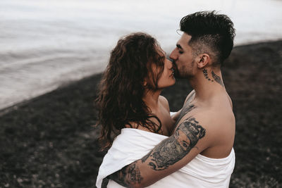 Young couple kissing on beach