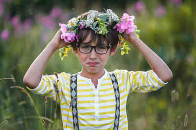 Portrait of girl standing on flowering plant